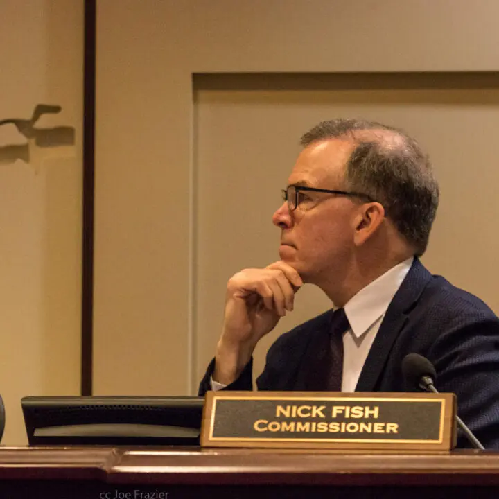 Commissioner Nick Fish intently listening at a Portland City Council meeting.